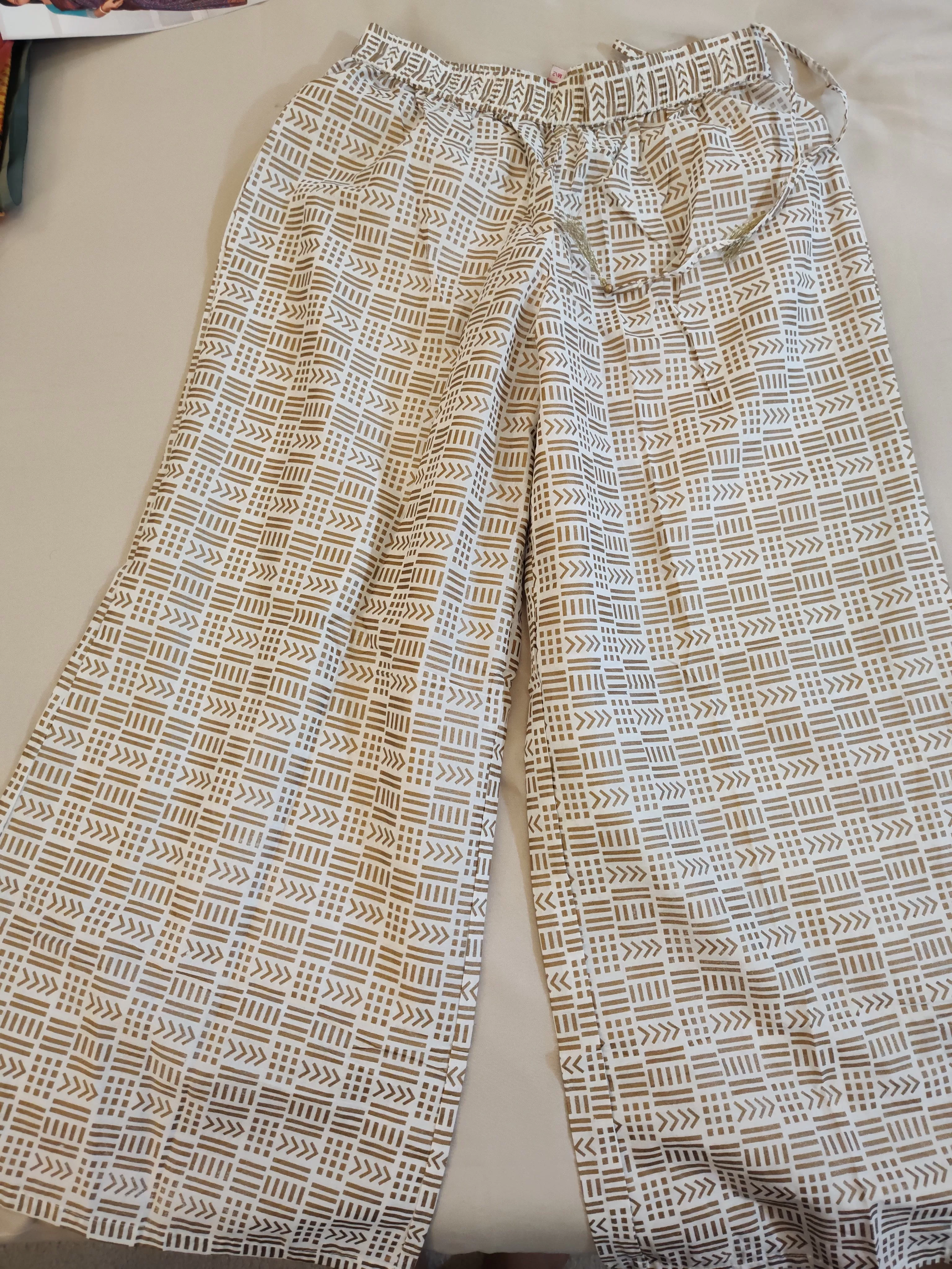 Alluring White Colored Palazzo Pants With Gold Print For Women